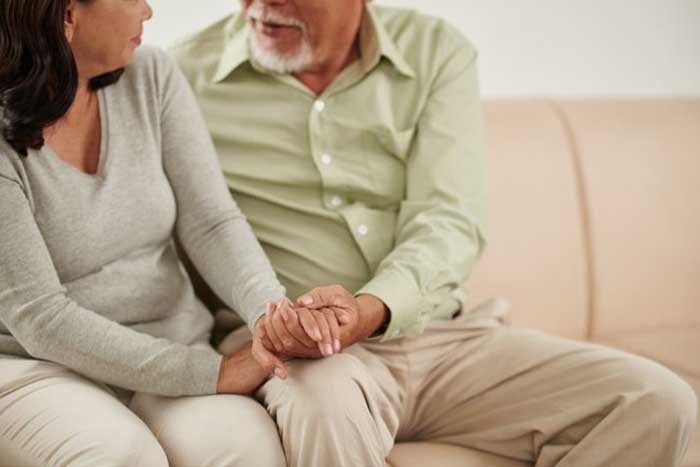 Elder Couple holding each other hand