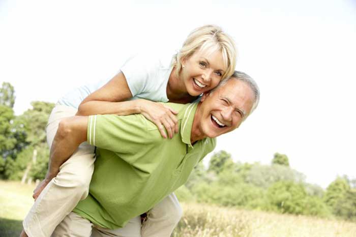 Happy couple walking on park