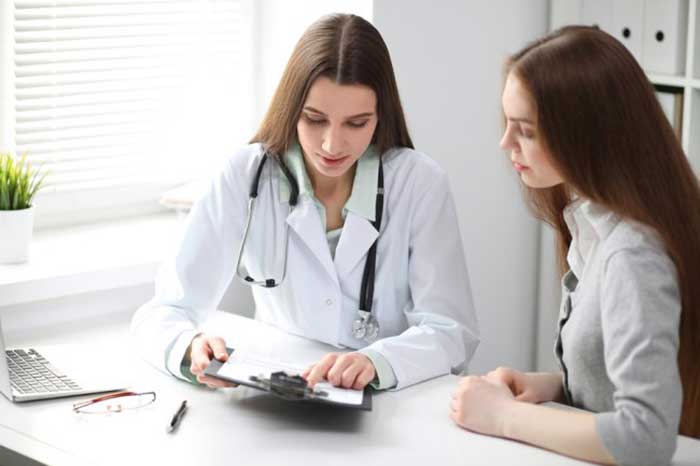 Female Doctor taking with patient