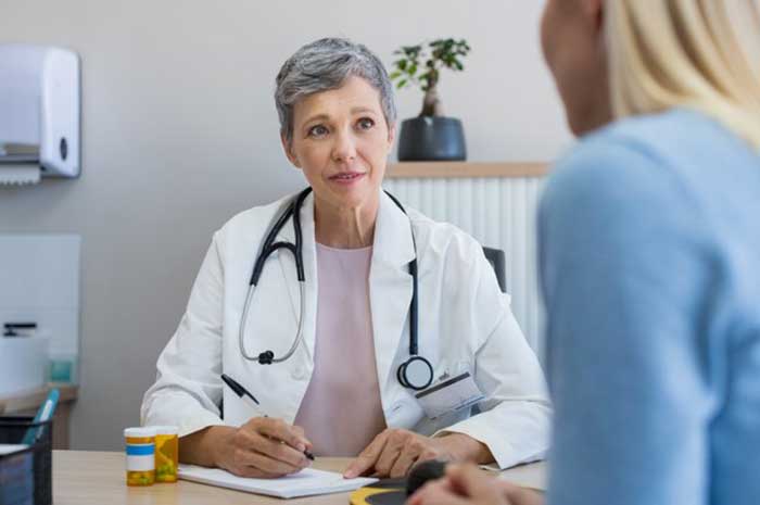 Female Doctor taking with patient