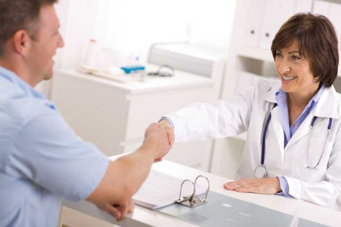 Female Doctor hand shaking with patient