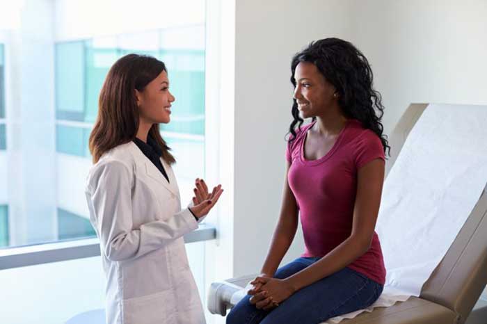 Female Doctor taking with patient