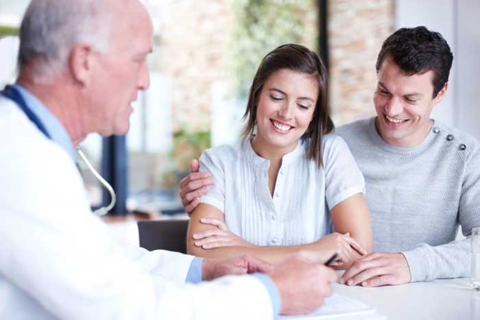 Doctor talking with couple patient