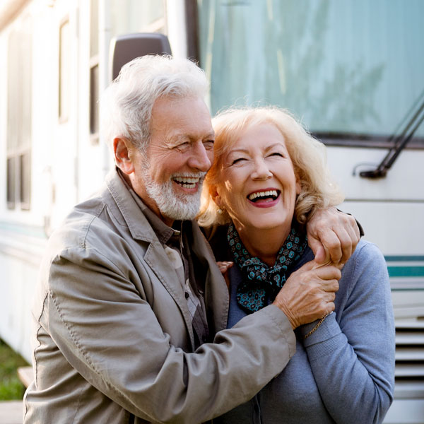 mature couple smiling by RV