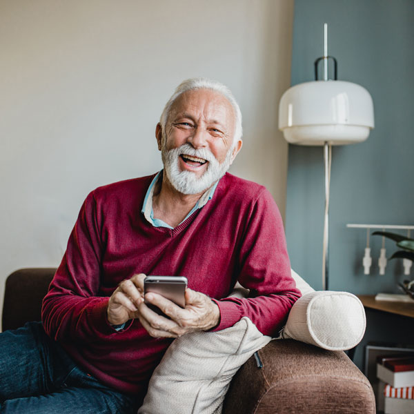 man with smartphone smiling
