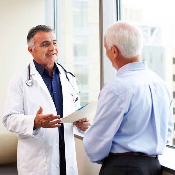 man talking to male doctor
